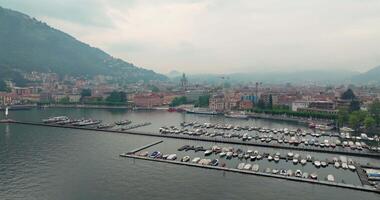 antenn se av de landskap av de sjö och de stad av como i Italien. marina med förtöjd båtar i de hamn, stadsbild av de gator av de stad i de alperna. hög kvalitet 4k antal fot video