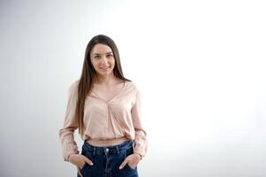 hands in pockets woman holding hands in pockets of blue jeans looking straight smiling on white background ad communication online learning clothing shop fitting room is space for text young girl photo