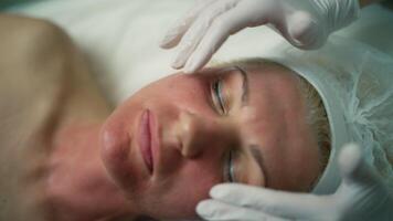 Enhancing Beauty and Wellbeing. Doctor's Facial Skin Prep and Bust Procedures for Comprehensive Beauty and Health Care in a Cosmetic Clinic. High quality 4k footage video