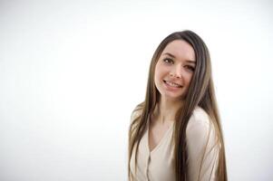 Beautiful positive friendly-looking young mixed race woman with lovely sincere smile feeling thankful and grateful, showing her heart filled with love and gratitude photo