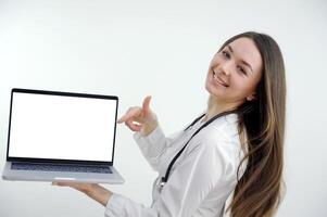 Happy doctor holding empty blank in hands. Female doctor showing a clipboard with blank paper. Close-up of a female doctor with lab coat and holding blank clipboard photo