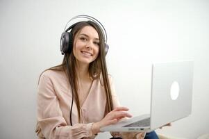 Engaged in distant training. Active young woman remote worker take part in virtual meeting using home computer. Female student participate in conference wearing headset. photo