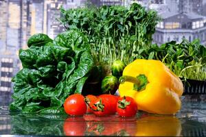 fresh farm vegetables. tomatoes, bell peppers, cucumbers, basil green onions and parsley with dill in drops of water. studio shooting, movements filmed with a slider, macro photography. photo