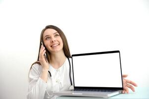 A female doctor working at the desk and pointing up isolated on white background photo