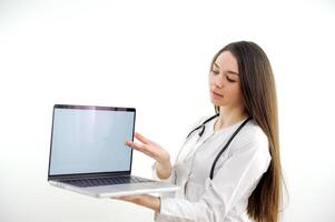 Doctor or nurse hold laptop computer in hands finger pointing digital screen isolated on a white background photo