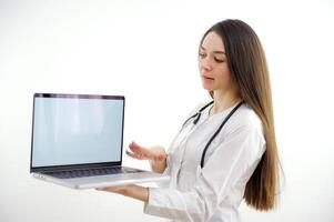 doctor holding tablet with blank screen for copy space. Female physician in uniform at hospital office. Medicine, healthcare and technology concept, copy space photo