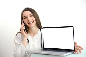 online medicine on the phone female doctor consulting a patient pleasant communication to help recovery patient gratitude laptop with a white screen in a hospital on a white background photo