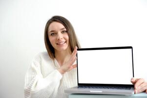 Woman freelancer is working on a new project on computer. White Display. photo