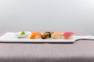 Asian Japanese food delicious restaurant beautiful serving white porcelain plate white background Sushi Set sashimi Tuna shrimp eel red fish salmon set of sashimi sushi with soy and chopsticks photo