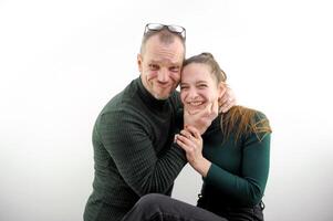 a happy loving couple fooling around and hugging at home in the kitchen. cozy and beautiful clothes for the house. romantic relationships. psychological assistance to young families. Valentine's Day photo