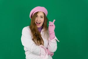 Hopeful woman with cancer wearing thoughtful pink scarf France fashion on green background chromakey. different emotions pink jacket gloves long brown hair. pink winter autumn knitted gloves on hands photo