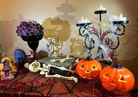halloween decorations candlestick on table Shrouded in cobwebs from all sides Two pumpkins are blinking nearby black vase in it with dried flowers Two skeletons take selfie with wasps stand on books photo