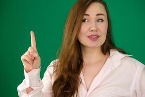 woman wearing turtleneck sweater over isolated background pointing with finger up and angry expression, showing no gesture photo