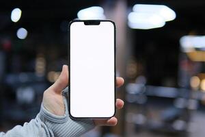 genial móvil oferta. dama señalando dedo a teléfono inteligente emocionalmente reaccionando a nuevo aplicación, teléfono con un blanco pantalla en manos en el gimnasio de cerca gris ropa con largo mangas publicidad espacio para texto foto