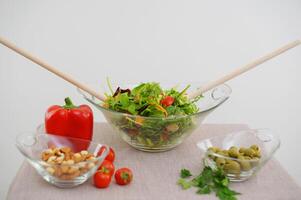 on table beige tablecloth close-up fresh cooked salad with wooden spoons on white background healthy eating concept delicious food space for text restaurant advertisement menu nude photo