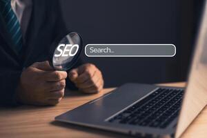 Businessman standing in suit holding magnifying glass.Searching Browsing Internet Data Information with blank search bar. Search Engine Optimization SEO Networking Concept. photo