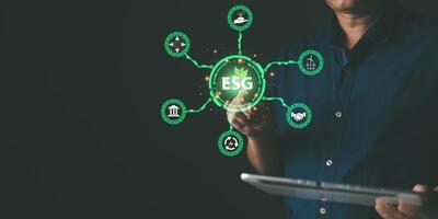 ESG for Environment Social and Governance. hand hold hologram screen to save energy,and reduce global warming,sustainable business investments,carbon credit,eco-friendly investment. photo