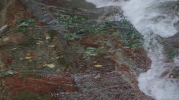 Light water close-up.Creative.A small waterfall that flows down the stones with clear water and slightly bubbling. video