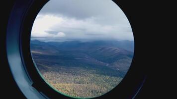 Beautiful forest in the frame. clip. The camera exits the window of the ship to the forest. Beautiful tourist views from the helicopter window video
