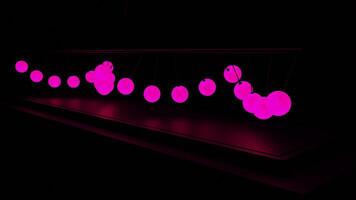Dark background. Design. A black background on which bright pink balls in abstraction oscillate one after another from side to side. video