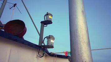 Boat lights. clip. Bright lights illuminate part of the boat. Part of a boat that has different things on it video