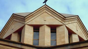 Close-up of the top of the building. ACTION. Top of the brown temple. A beautiful temple stands against the backdrop of a blue sky video