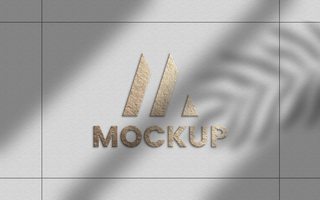 Gold foil logo mockup on wall psd