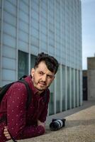 Urban Chic Stylish Man with Black Backpack and Glasses in Cityscape photo