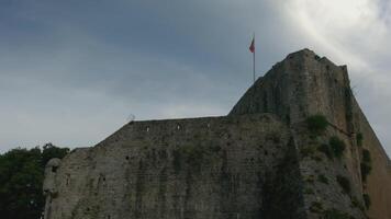 Ancient castle on blue cloudy sky background. Creative. Bottom view of a stone fortress, concept of architecture and history. video