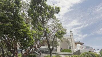 Vorontsov Palace is located on the southern coast of Crimea in the city of Alupka with a view of Ai-Petri and the Black Sea. Action. The castle is next to green trees and against a bright blue sky video