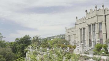 Vorontsov Palace is located on the southern coast of Crimea in the city of Alupka with a view of Ai-Petri and the Black Sea. Action. The castle is next to green trees and against a bright blue sky video