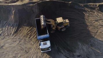 Excavator clearing beach. Scene. Top view of clearing of beach area. Excavator and dump trucks clean coastal part in summer. Construction work on beach video