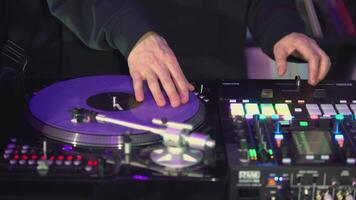 DJ's hands on the mixing console close-up. ART. The DJ is playing a musical set. The guy plays with his left hand on the soundboard of the DJ console video