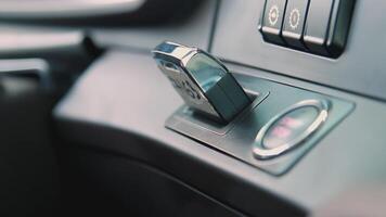 The key is in the ignition. SCENE. In a dark interior, a key is inserted into the car ignition. The car key is inserted next to the ignition button video