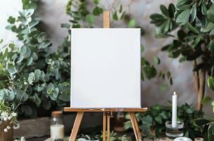 White Easel Surrounded by Plants and Candles photo