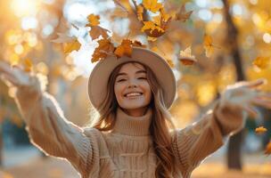 Woman With Hands Raised Surrounded by Leaves photo
