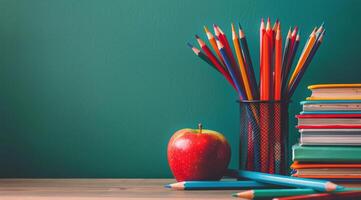 Books, Pencils, and Apple on Table photo