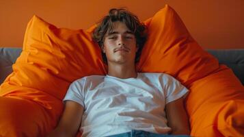 Young Man Sitting on Bean Bag Chair photo