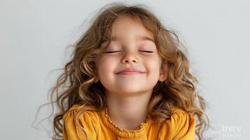 Little Girl With Curly Hair Smiling at the Camera photo