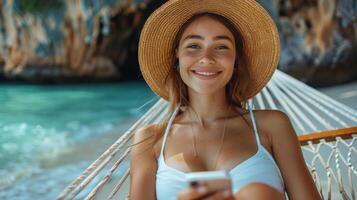 Beautiful Woman in White Bikini Sitting in a Hammock photo