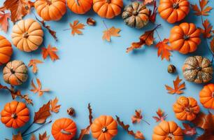 Group of Pumpkins and Leaves on Blue Background photo