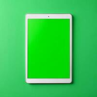 tablet with green screen on a green background photo