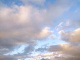 Sun Setting Over Clouds in Sky photo