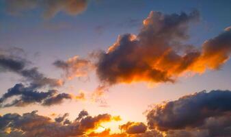 Sun Setting Over Clouds in Sky photo