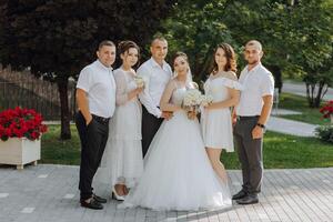 A group of people, including a bride and groom photo