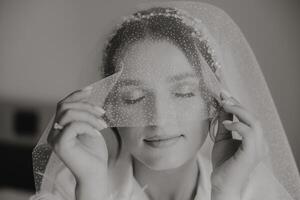 A woman is wearing a veil and looking at the camera photo