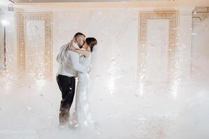 A bride and groom are dancing in the air with confetti falling around them photo