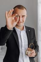 A man in a suit holding a box of gold and diamonds photo