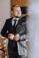 A man in a suit is getting ready for a formal event photo