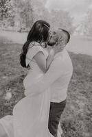 A man and woman are kissing in a field photo
